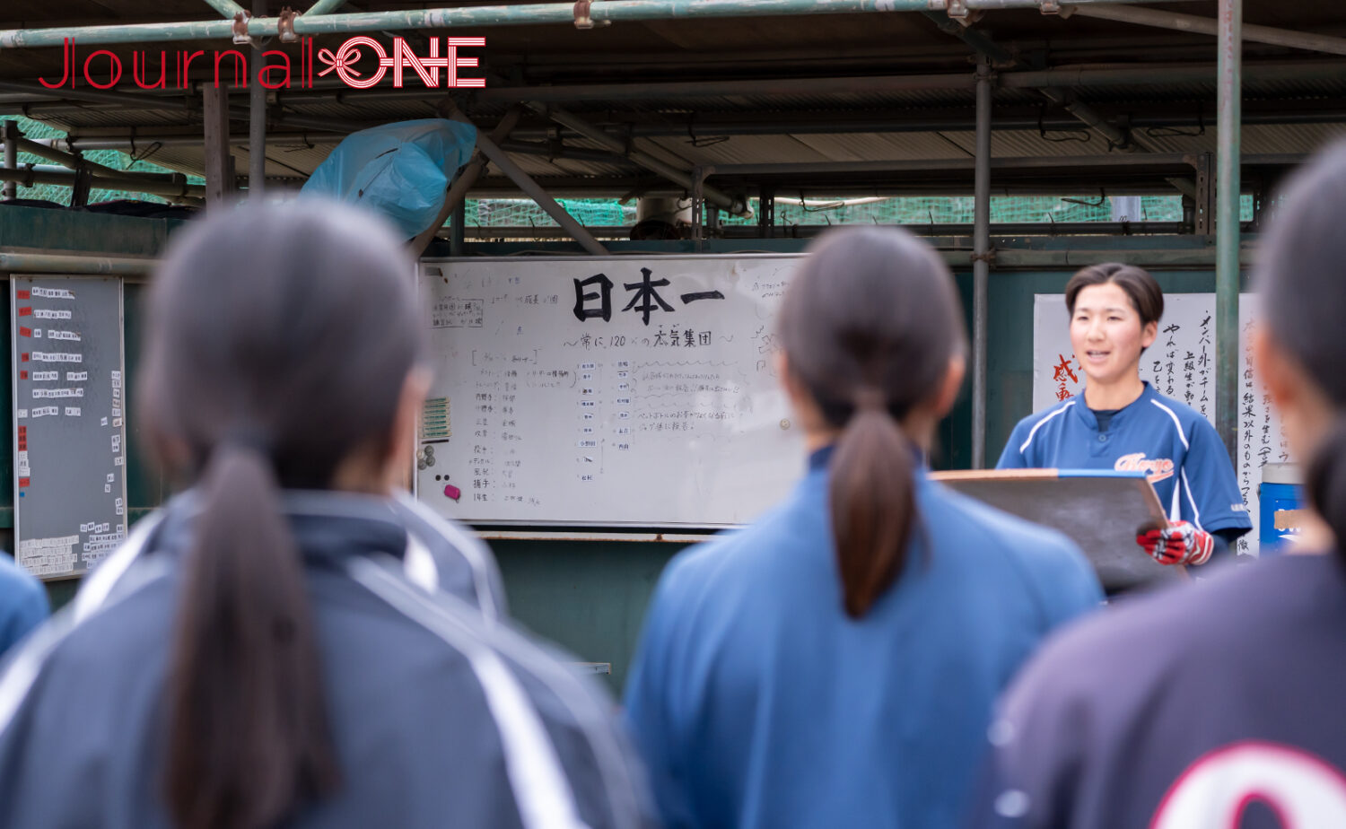 日本一の看板を掲げたベンチ前で西垣美来副将がメニューを伝える‐Journal-ONE撮影